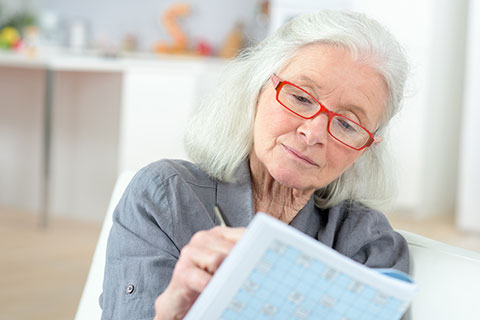 Senior woman taking notes on estate planning